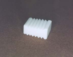 Figure 4 : Electron microscope: bone/biotitanium active interface Figure 4 Histological cross-section of the interface between the newly created bone tissue and bioactive surface 2 months after the implantation (original magnification 200x, stained with toluidine blue). The figure showing high value of Bone Implant Contact (BIC=91%) 2 months after the implantation indicating excellent osseoconductive properties of bioactive titanium.The material is of black-gray color with a density of 4,500 kg*m -3 and its tensile strength is at least 450 MPa. On the prism´s opposite sides adjacent to vertebral bodies after the application, the implant is fitted with sharp wings of 0.5 mm in height and 30degree angulation. These ensure primary stability for undisturbed healing and incorporation of the implant into the surrounding vital bone tissue. The shape and size was supported by biomechanical studies, see Figure5.